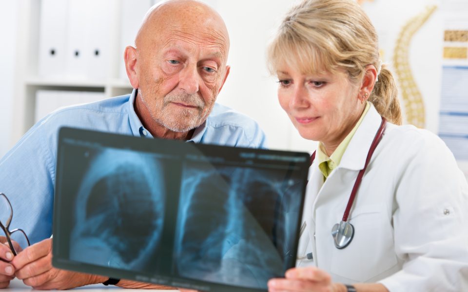 Doctor explaining x-ray results to senior patient