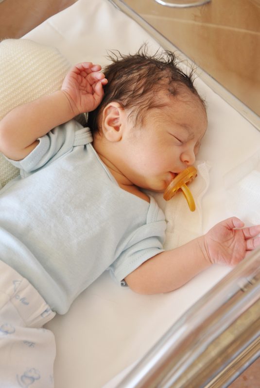 Newborn Infant Baby Boy in Acrylic Hospital Basinet