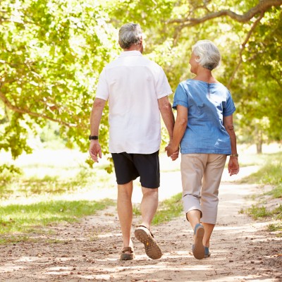 Senior couple walking on outdoor trail