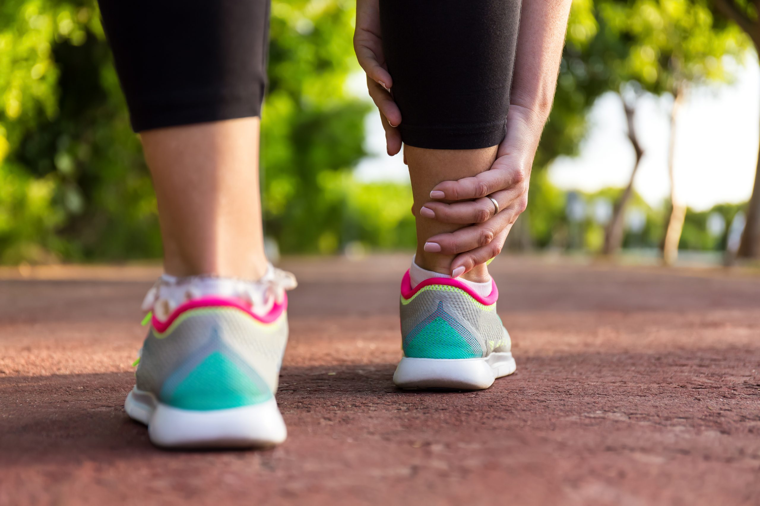 woman walking and grabbing ankle in pain | Fairfield Medical Center